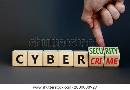 Cyber-security vs cybercrime symbol. Businessman turns wooden cubes, changes words Cybercrime to cyber-security. Beautiful grey background. Cyber-security vs cybercrime concept. Copy space.