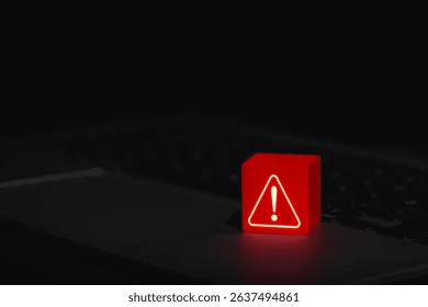 Cybersecurity Warning Alert Symbol. Glowing red warning triangle block with exclamation mark placed on laptop, symbolizing system threat or cyber security alert. system error, virus, spyware, malware,