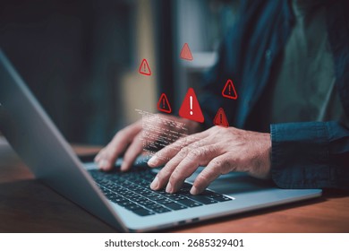Cybersecurity warning concept with hacker hands typing on laptop showing error alert signs. Data protection, malware attack, online security risk and system breach.