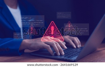 Cybersecurity warning concept. Warning icon and programming code. Data breach, system error, hacking attempt, software development issues and bug fixing process. Cyber security and IT support.