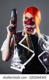 Cyborg Mercenary In Asian Demon Mask, Young Woman With Bright Orange Hair With A Gun In Her Hands, Futuristic Cyber Punk Style