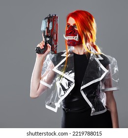 Cyborg Mercenary In Asian Demon Mask, Young Woman With Bright Orange Hair With A Gun In Her Hands, Futuristic Cyber Punk Style