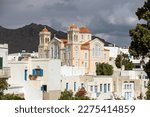 Cyclades, Greece. Tinos Greek island, Pyrgos village Agios Nikolaos church and white color buildings, cloudy sky