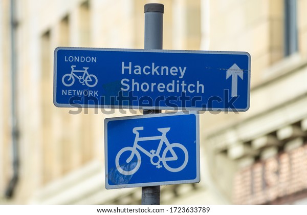 A cycle\
route sign in central London directs bike riders towards Hackney\
and Shoreditch along the cycle\
network
