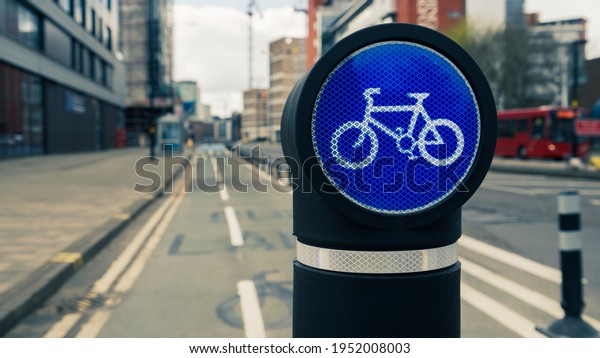Cycle route sign\
on a bollard in a city\
centre