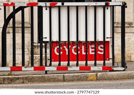 Cycle sign behind bars and gate
