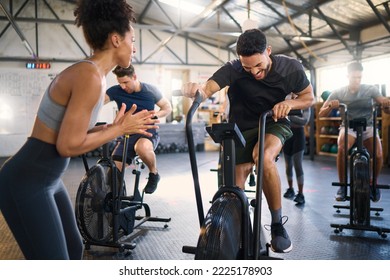 Cycle spinning, fitness and applause of a coach with motivation for cycling gym training. Sports coach clapping for workout, wellness and bike exercise success of people on bicycle happy from cardio - Powered by Shutterstock