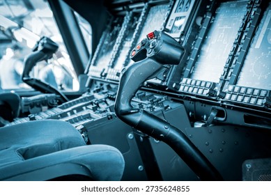 Cyclic control stick inside a helicopter cockpit, used for directional flight control.
