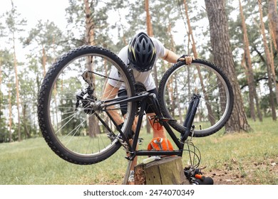 Cycling, adventure trail and bike repair, man fix wheel in forest. Nature, mountain biking and cyclist, outdoor cycle maintenance in Australia. Bicycle ride, dirt path and biker stop for tyre change. - Powered by Shutterstock