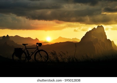 Cycling around the world Is a journey to freedom.Appreciate the beauty of nature and sunset in the valley.