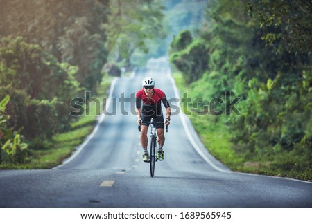 Cycling competition, cyclist athletes riding a race at high speed on mountain road, Sportsmen bikes in the morning,