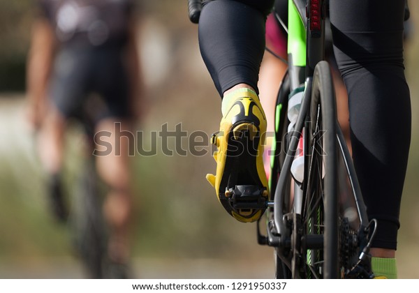 Cycling competition cyclist athletes riding\
a race at high speed, detail of cycling\
shoes