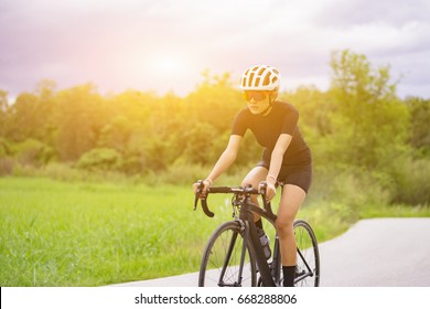 Cycling competition,cyclist athletes riding a race at high speed on mountain road, Sportswomen bikes in the morning,vintage color,selective focus, sports concept,Business competition,copy space - Shutterstock ID 668288806