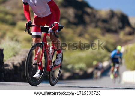 Cycling competition,cyclist athletes riding a race, climbing up a hill on a bicycle