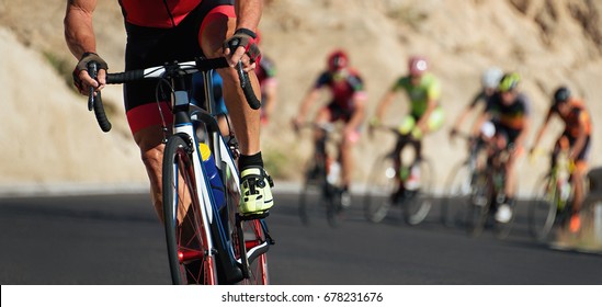 Cycling competition,cyclist athletes riding a race,climbing up a hill on a bicycle