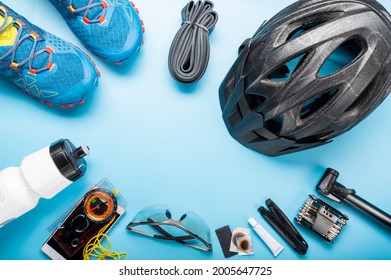 Cycling equipment is laid out in a circle. Emptiness in the middle of the circle. Place for the inscription cycling composition.