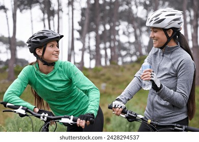 Cycling, fitness and friends in nature talking of training, race or journey with break and stop in the forest. Happy women or people drinking water, bicycle and conversation for exercise and teamwork - Powered by Shutterstock