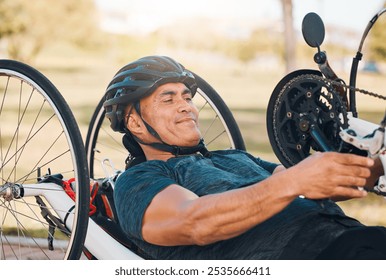 Cycling, fitness and man with disability in race, training for competition with smile, motivation and exercise on bike. Sports, workout and person on handcycle bicycle on outdoor track for challenge. - Powered by Shutterstock