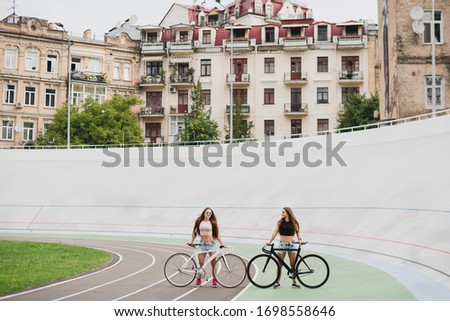 Similar – Happy young people walking along road in summer day