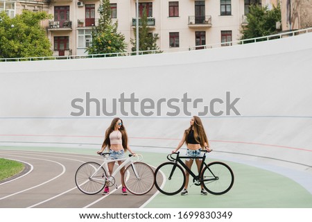 Similar – Happy young people walking along road in summer day