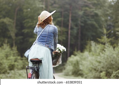 Cycling in the forest by fashion woman 