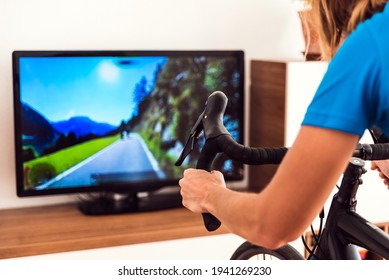 Cycling Indoor With Exercise Bike Trainer Motivating Himself With The Gamification Of Sport.