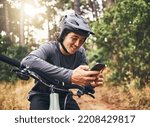 Cycling man in forest, phone gps and map direction with adventure, nature trail and bicycle break in woods. Happy mountain bike sports athlete, mobile app search and typing location guide connection