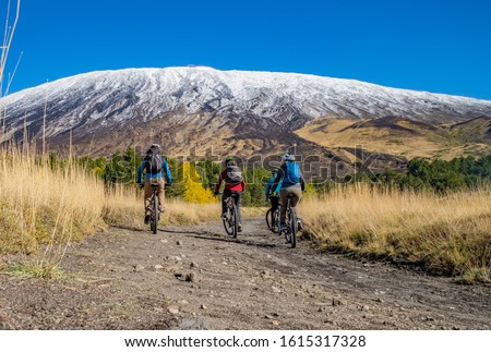 Cycling, mountain biker on cycle trail in autumn forest. Mountain biking in autumn landscape forest. Volcano Etna. Sicily