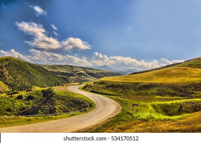 Cycling mountain road. Misty mountain road in high mountains.. Cloudy sky with mountain road  - Powered by Shutterstock