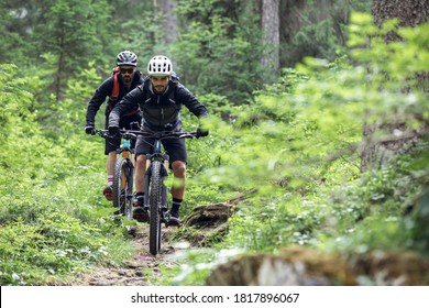Cycling outdoor adventure. Two cyclists with enduro mtb bikes in forest in the Italian alps. Cycling e-mtb enduro trail track. Outdoor sport activity. At the lago di braies, Dolomites, Italy - Shutterstock ID 1817896067