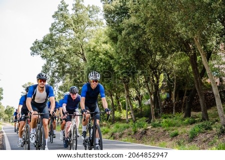 Cycling peloton of different age groups on a mountain road
