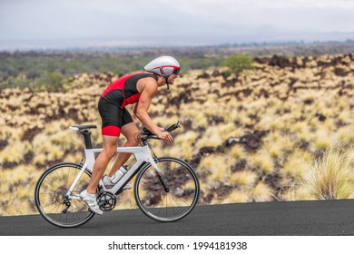 Cycling Sport Athlete Man Biking On Triathlon Bike. Fit Male Cyclist On Professional Triathlon Bicycle Wearing Time Trial Helmet For Iron Man Race Exercising In Kailua Kona, Big Island, Hawaii, USA.