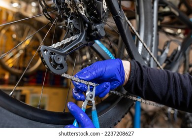 Cycling technician repairing and maintaining bike and gear shifter in workshop - Shutterstock ID 2237208627