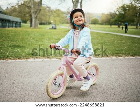 Cycling, thinking and child on a bike in the park, outdoor activity and learning in New Zealand. Sport, happiness and girl kid playing on bicycle ride in the neighborhood street or road in childhood