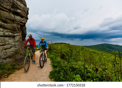 Cycling woman and men riding on bikes at sunset mountains forest landscape. Couple cycling MTB enduro flow trail track. Outdoor sport activity. - Shutterstock ID 1772150318