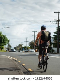 Cycling To Work On The Road With Out-of-focus People Doing Their Morning Walk. Vertical Format. 