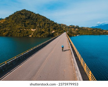 cyclist bridge river sea mountain nature sport - Powered by Shutterstock