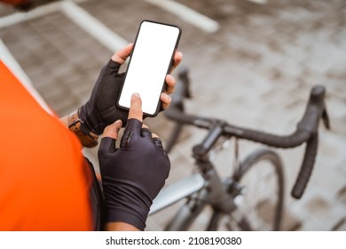 cyclist check his workout progress on a smart phone - Powered by Shutterstock