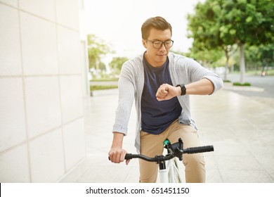 Cyclist Checking Time On His Watch