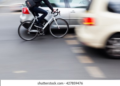 Cyclist In City Traffic In Motion Blur