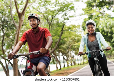 Cyclist couple riding together in a park