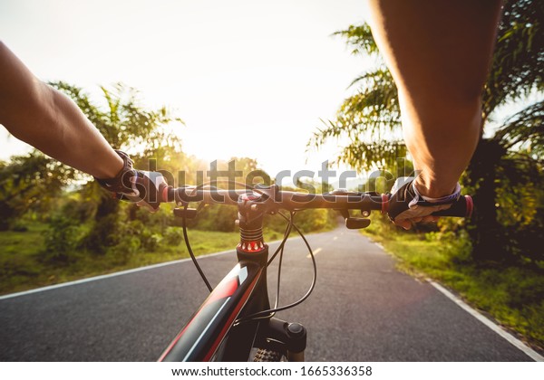 Cyclist\
cycling mountain bike on tropical forest\
trail