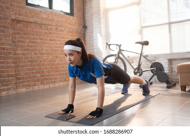 Cyclist exercise with push-ups. She's at home.