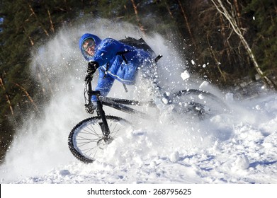 Cyclist Extreme Riding On Mountain Bike In Sunny Snow Forest