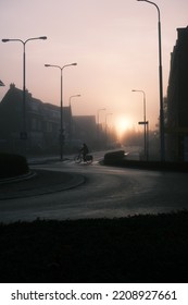 Cyclist At Foggy Morning In City