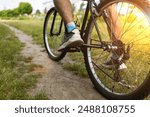 Cyclist in helmet resting on the sand in the park. cyclist riding on bike in nature for adventure, journey and transport.