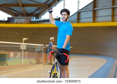 Cyclist Making Triumphant Gesture On Indoor Track