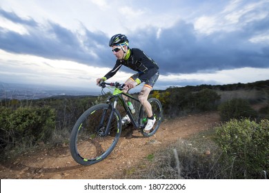 Cyclist man riding mountain bike on mountain.