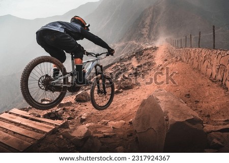 Cyclist in the mountains, practicing Enduro MTB.