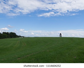 Cyclist on a mountain and clouds in the background